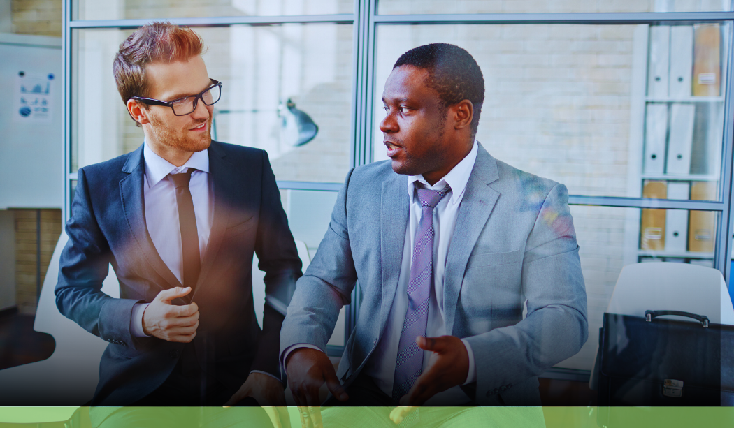 two male professionals discussing the implementation of Power BI